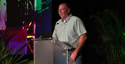Corn yield world record holder Dave Hula taking the stage at the Yield Hero 2022 Gala. 