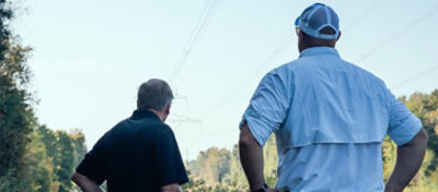 Men looking at a utility ROW