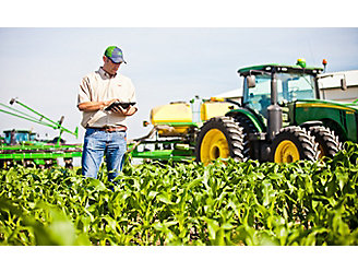Farmer checking corn field using tablet