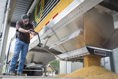 man emptying harvested corn