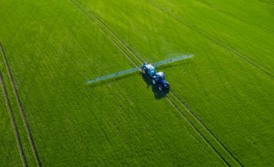 Image of tractor spraying field