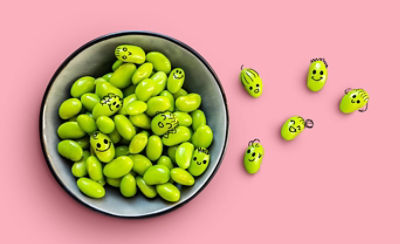 A bowl full of peas with faces