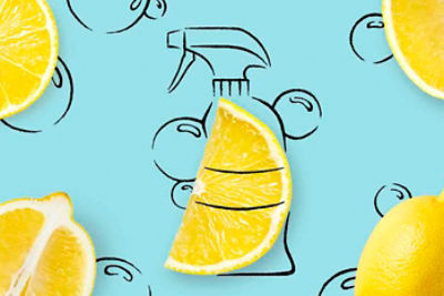 Cut-open lemons with a drawing of a spray bottle and bubbles in the background