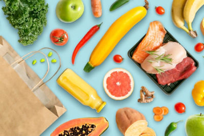 Array of meats, fruits, vegetables spread out.