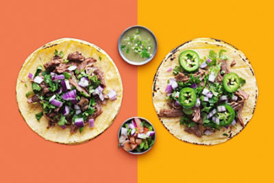 Two Tacos and Two Salsas on a Brightly Colored Background
