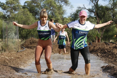 Amelia & Karen supporting each other through the mud pit
