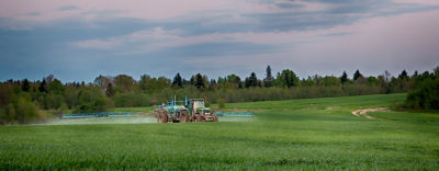 Tractor spraying field