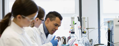 Scientist using microscope in laboratory
