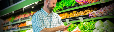Man in grocery store in produce aisle