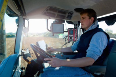 Young man drives tractor