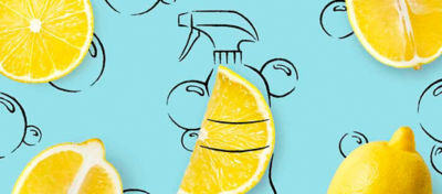 Cut-open lemons with a drawing of a spray bottle and bubbles in the background