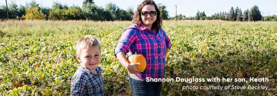 photo of Sharon Douglass and her son in crop field